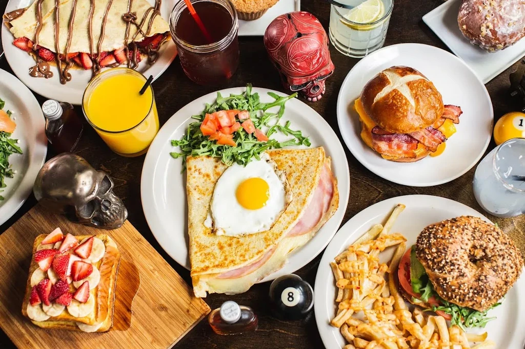An overhead shot of a table covered with plates of breakfast foods.