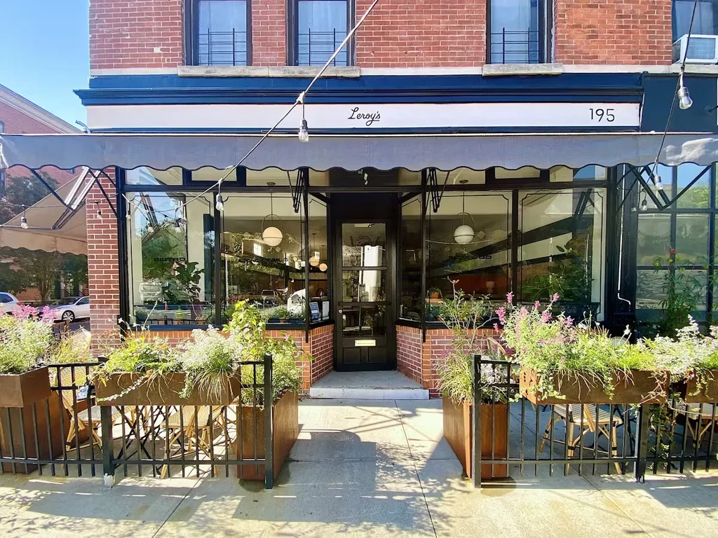 A red brick storefront with "Leroy's" and "195" above a gray awning.