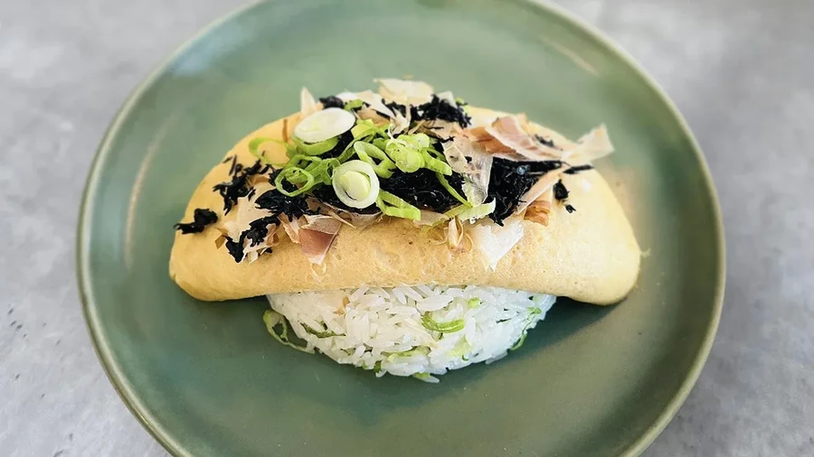 Omurice: omelet over rice, topped with seaweed, scallions, and bonito flakes.