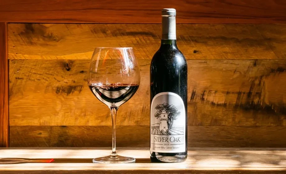 Silver Oak 2015 Cabernet Sauvignon bottle and partially filled glass.