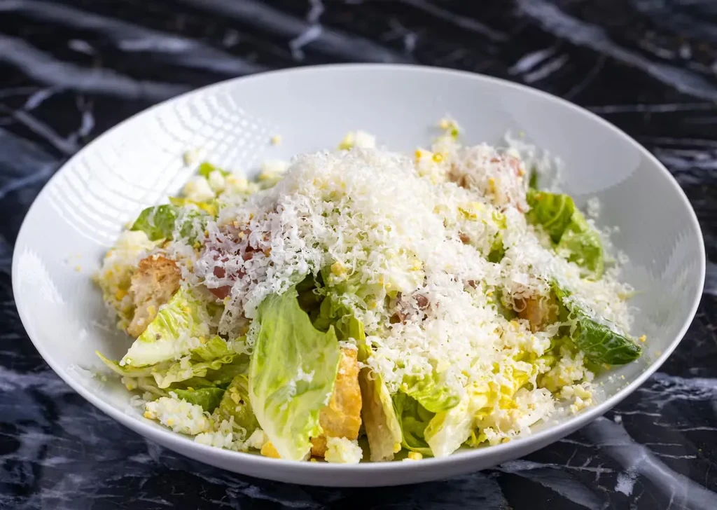 Generous Caesar salad with romaine, croutons, eggs, and grated Parmesan.