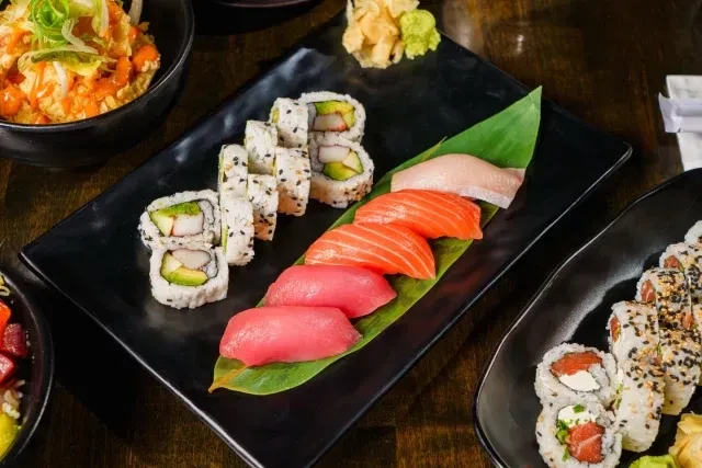 Spread of maki and nigiri sushi, sashimi, with ginger and wasabi.