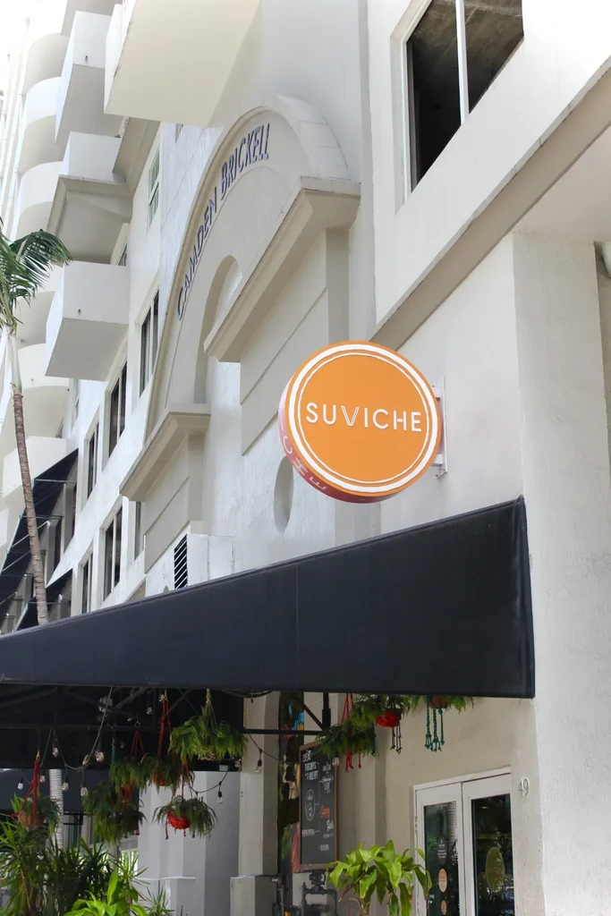 Suviche restaurant exterior in Camden Brickell with outdoor plants and awning.