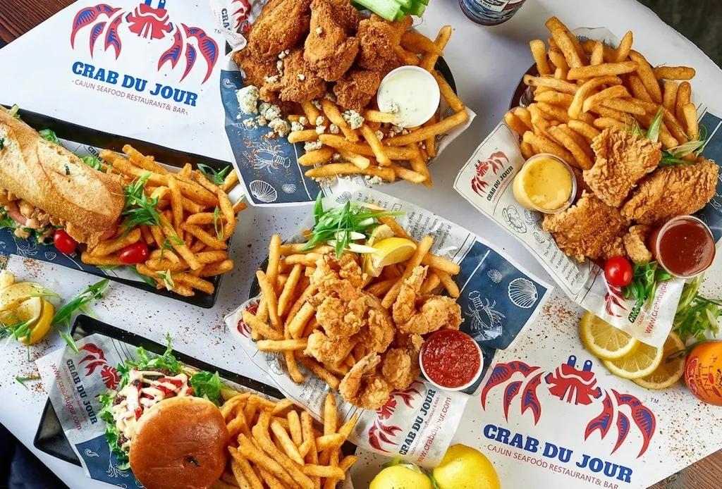 Overhead shot of fried chicken, shrimp, po'boy, and fries from Crab Du Jour.