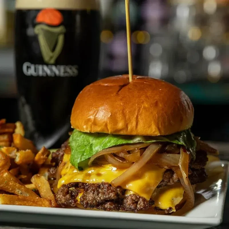 Double beef cheeseburger, golden fries, and a Guinness stout.