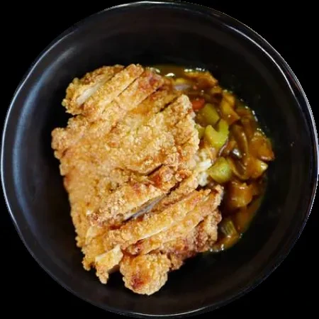 Sliced fried chicken cutlet, white rice, and vegetable curry in dark bowl.
