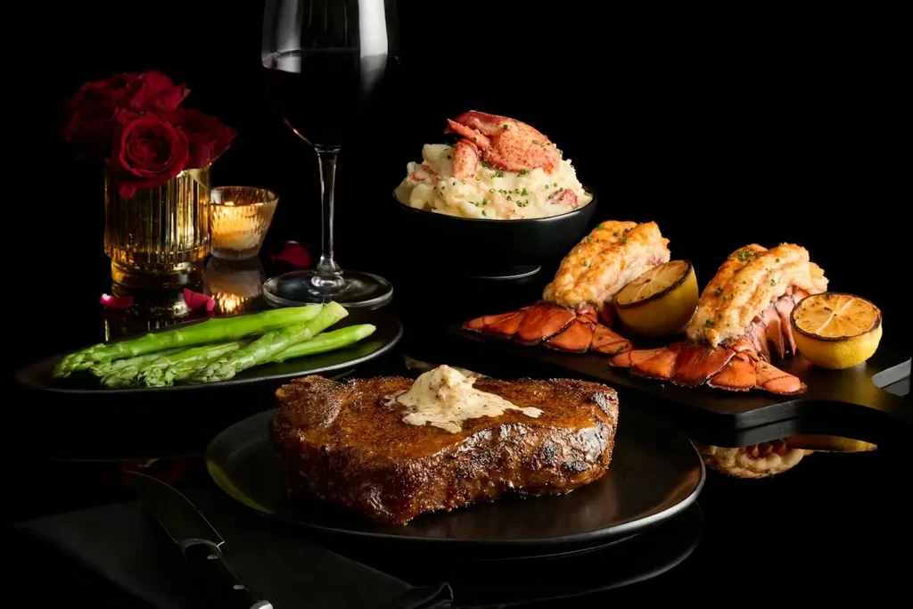 Seared steak, grilled lobster, asparagus, mashed potatoes, and red wine dinner.