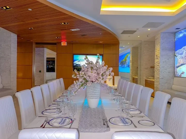 Impeccably set elegant dining room with cherry blossoms and digital landscapes.