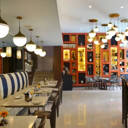 Modern restaurant interior with striped booth and illuminated display wall.