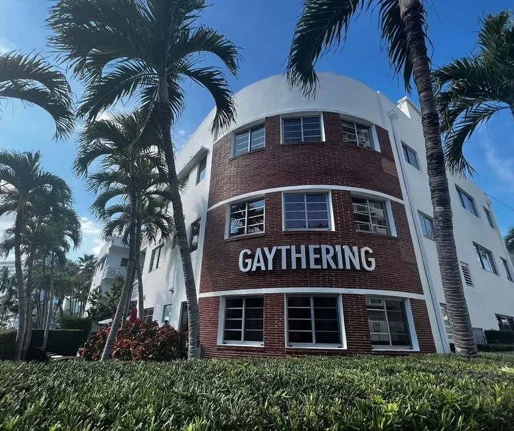 Art Deco GAYTHERING building with curved brick facade and palm trees.