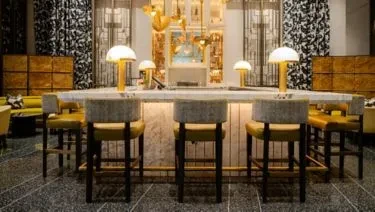 Sophisticated bar with modern stools and glowing mushroom lamps.