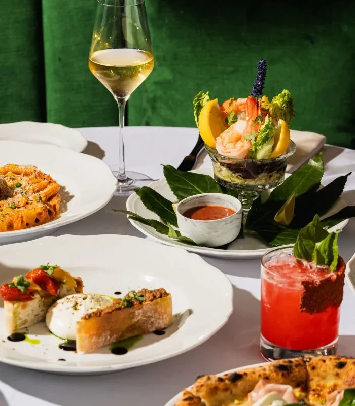 A well-appointed restaurant table displaying various gourmet food and drinks.