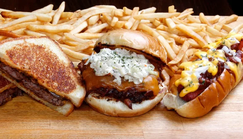 Grilled sandwich, burger, and loaded hot dog with fries.