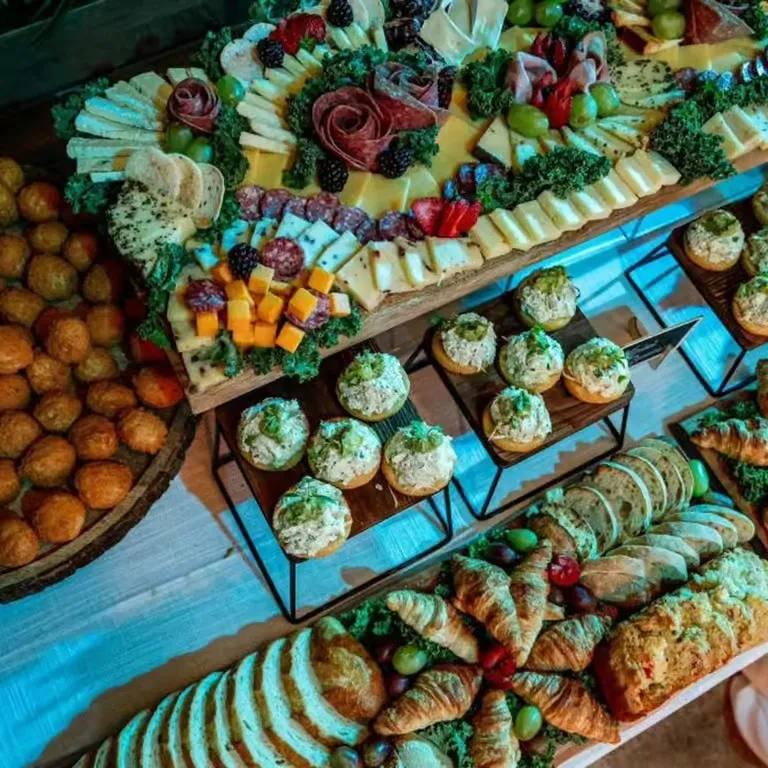 Large buffet spread featuring charcuterie, breads, pastries, and appetizers.