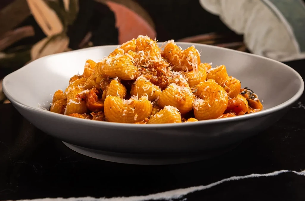 Short ridged pasta shells with tomato sauce and grated cheese.