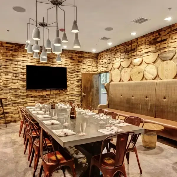 Private dining room: long table, wood walls, and modern chandelier.