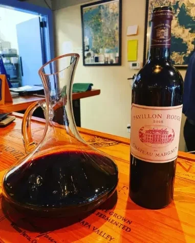 Decanter with red wine and Pavillon Rouge 2016 Chateau Margaux bottle.