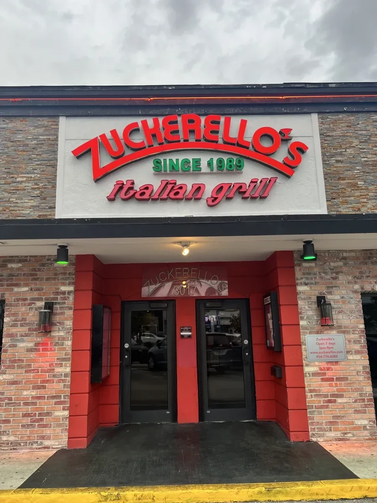 Zuckerello's Italian Grill restaurant facade with large red sign.