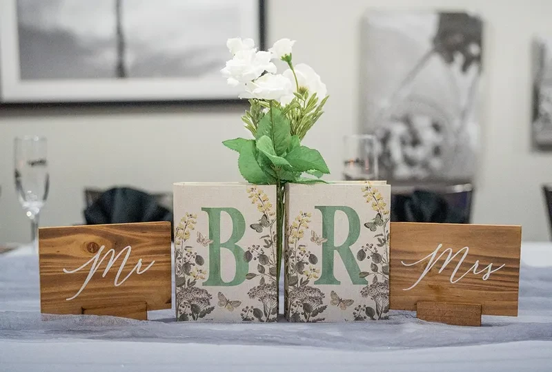 Decorated wedding table with Mr, Mrs signs and floral B, R blocks.