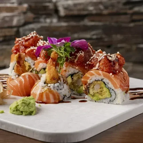Sushi rolls with salmon, fried shrimp, spicy tuna, wasabi, and ginger.