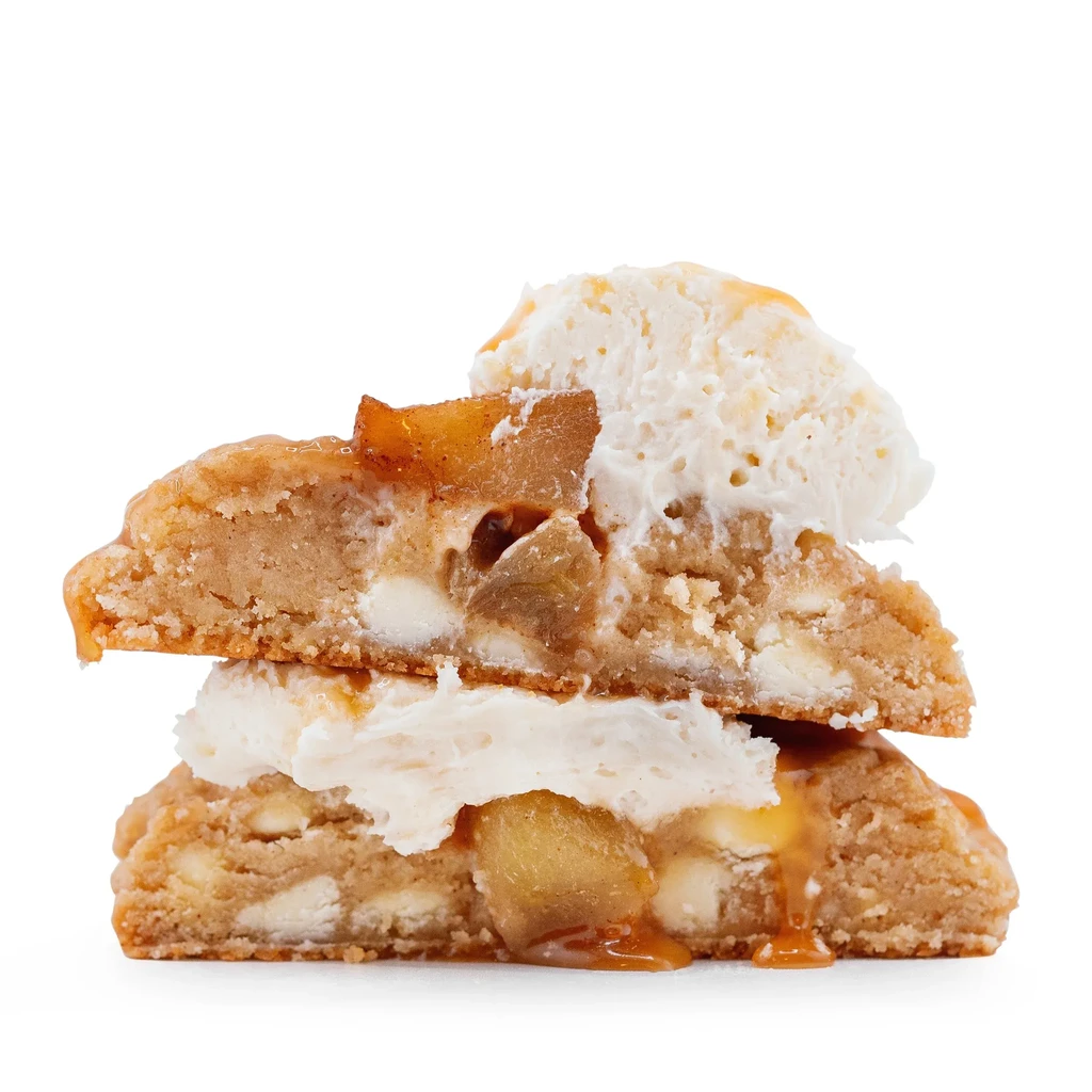 Stacked apple blondies with creamy topping and caramel sauce.