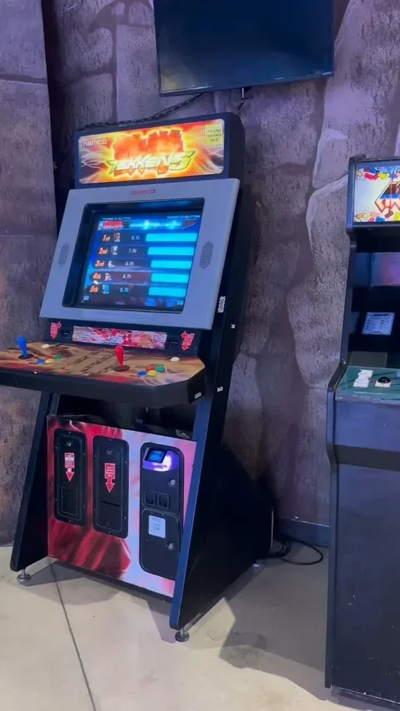 Two arcade machines, including Namco Tekken 5, in an entertainment space.