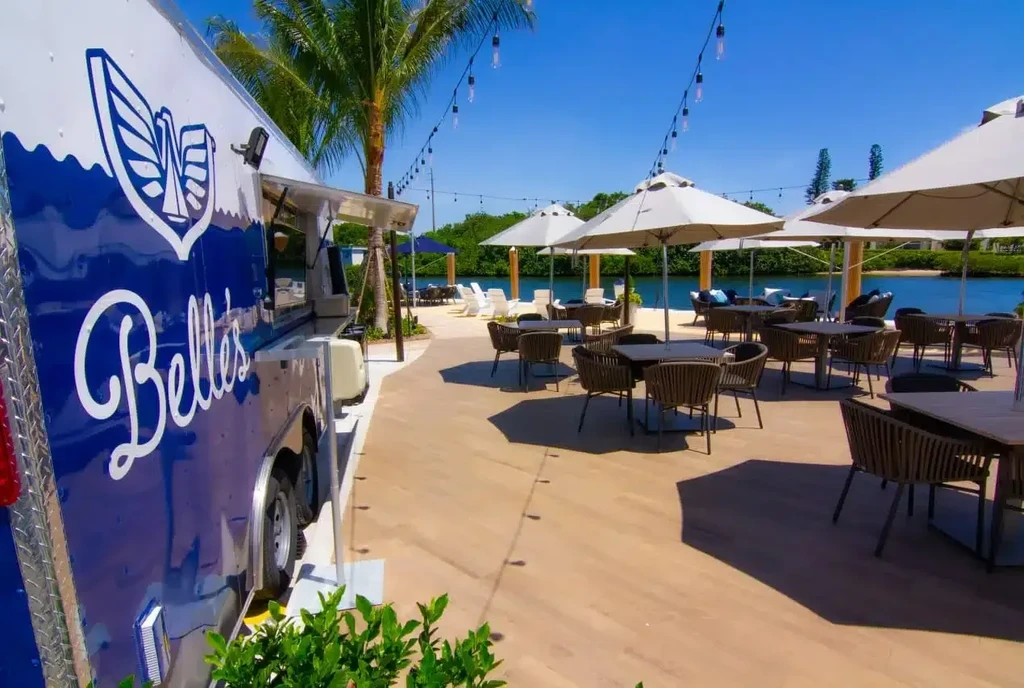Belle's food truck, outdoor dining and lounge area by water.