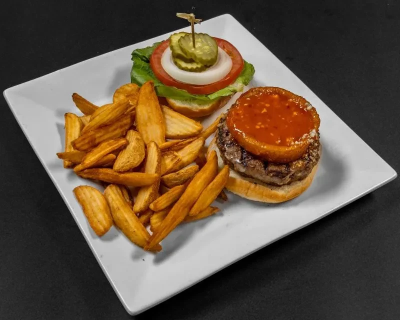 Two open-faced mini burgers and golden potato wedges on plate.