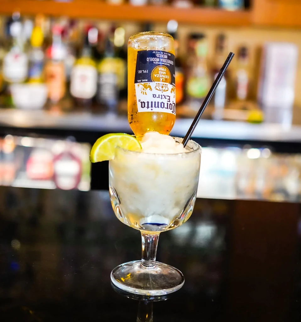 Close-up of a Coronarita cocktail, garnished with lime and salt.