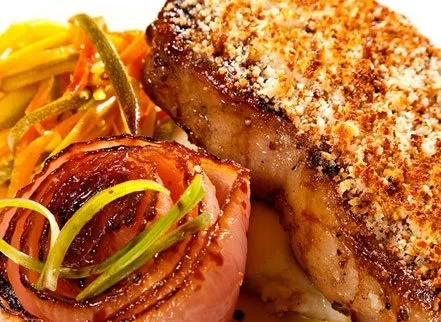 Crusted meat, roasted onion with herbs, and julienned vegetables.