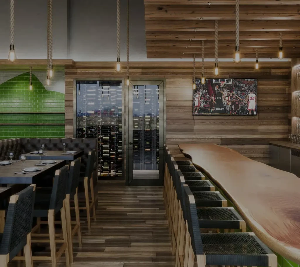 Modern rustic restaurant interior with dining booths, wine display, and live-edge bar.