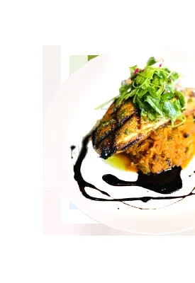 Grilled protein, orange puree, arugula, balsamic drizzle on white plate.