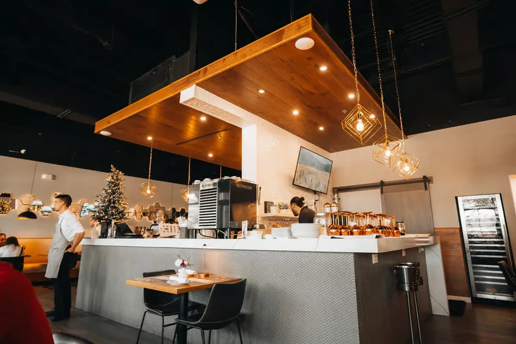 Modern cafe bar with staff, Nespresso machine, and Christmas tree.