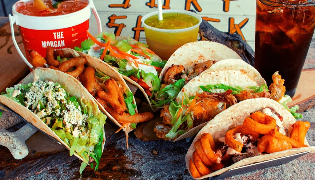 Tacos with fries, drinks, and alligator head at Thirsty Shack.