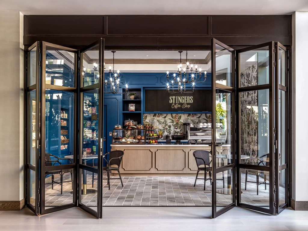 Stingers Coffee Shop interior with blue accent wall and pastry display.