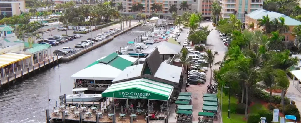 Waterfront restaurant Two Georges Grille, green awnings, outdoor dining.