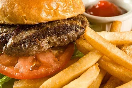 Classic burger, crispy fries, and ketchup in a ramekin.