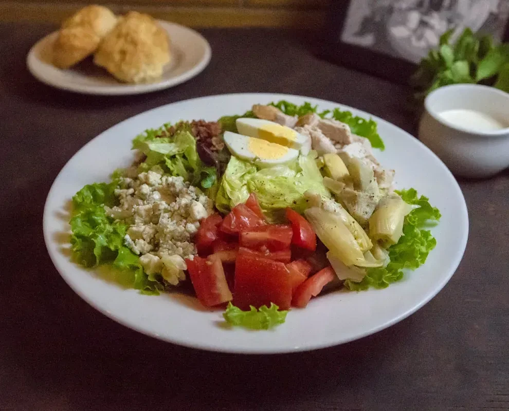 Vibrant Cobb salad with chicken, eggs, blue cheese, tomatoes, artichokes.