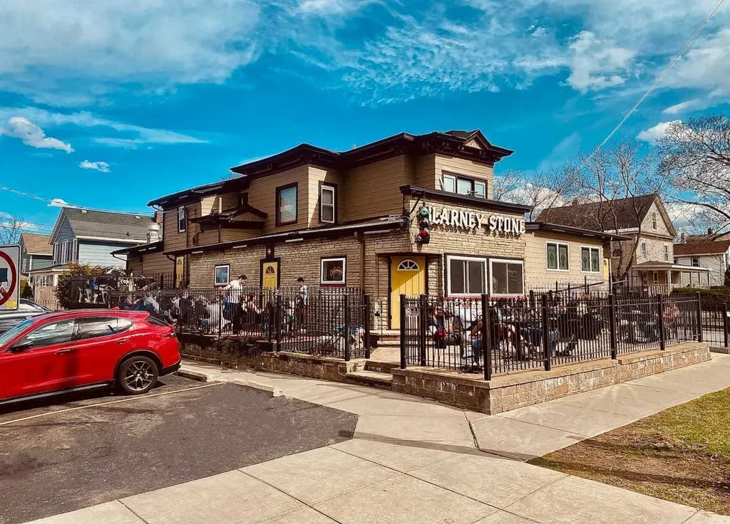 Kilcarney Stone restaurant with a lively outdoor patio on a sunny day.