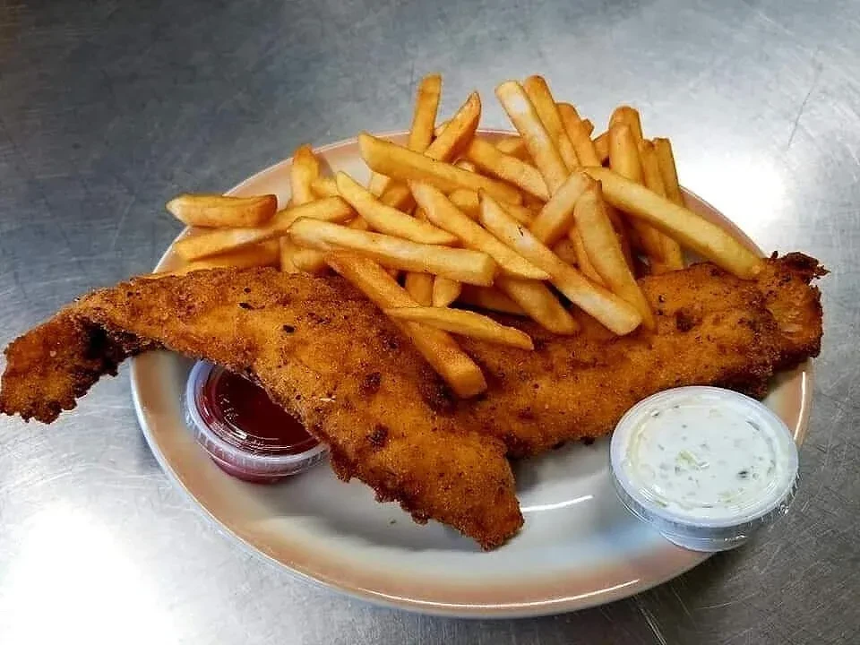 Fried fish and french fries with two sauces on a plate.