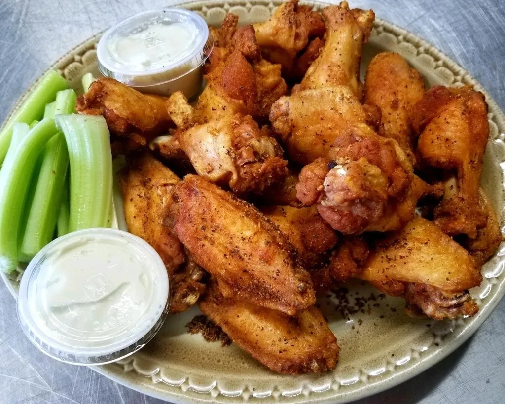Crispy golden-brown chicken wings, celery, and creamy dipping sauce.