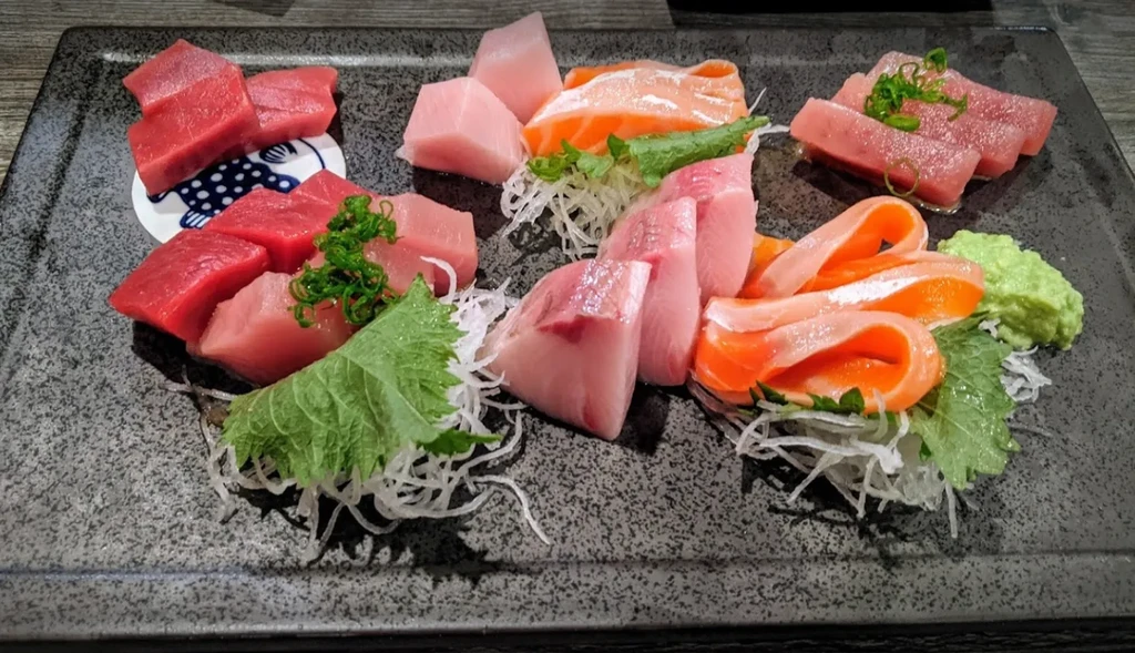 A platter of sliced sashimi: tuna, salmon, and other fish.