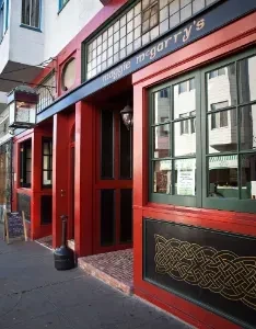 The red exterior of Maggie McGarry's Irish pub on a sunny day.