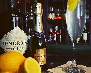Hendrick's Gin, Chandon Brut, lemon, and a cocktail in a bar.