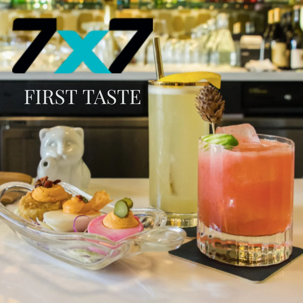 "7x7 First Taste" event, with appetizers and cocktails on a bar.