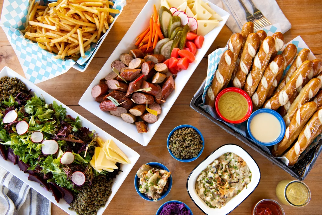 An overhead shot of a German-inspired meal on a wooden table.
