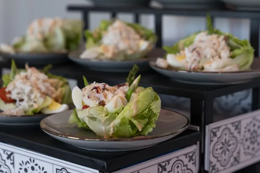 Individual crab salads with lettuce cups, hard-boiled eggs, and asparagus.