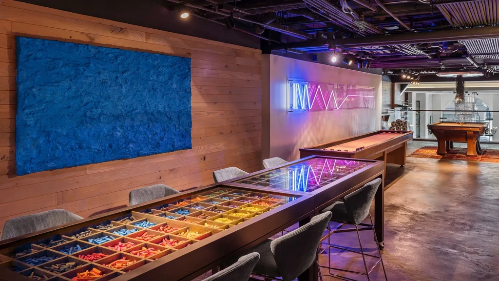 Recreational game room with shuffleboard, pool table, and board game table.