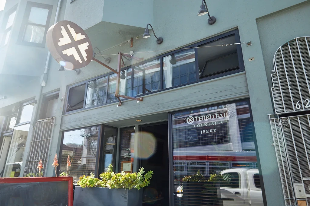 A daytime exterior shot of the Third Rail Cocktails & Jerky storefront.