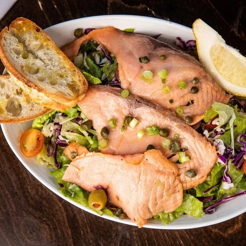Poached salmon fillets, capers, scallions, lettuce, tomatoes, lemon, and bread.